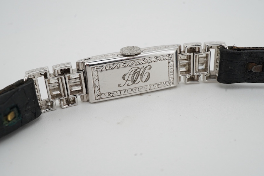 An Art Deco lady's diamond cocktail watch, 1930s, the rectangular silvered dial with blue steel hands, in a geometric case set with circular-cut and baguette diamonds, mounted in platinum, case width 1cm excluding winder